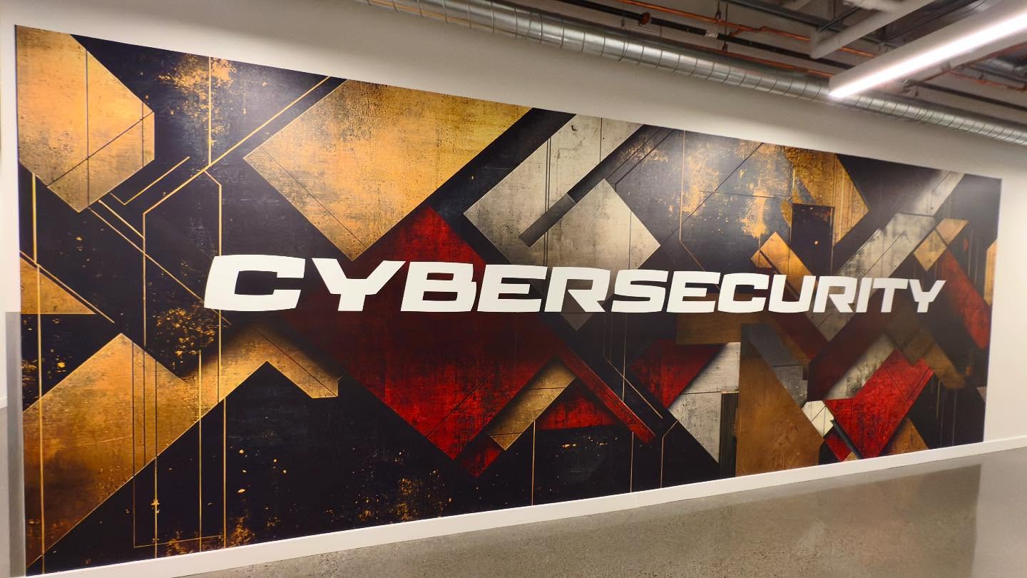 Public installation photograph documenting the cybersecurity wall at architectural scale.
