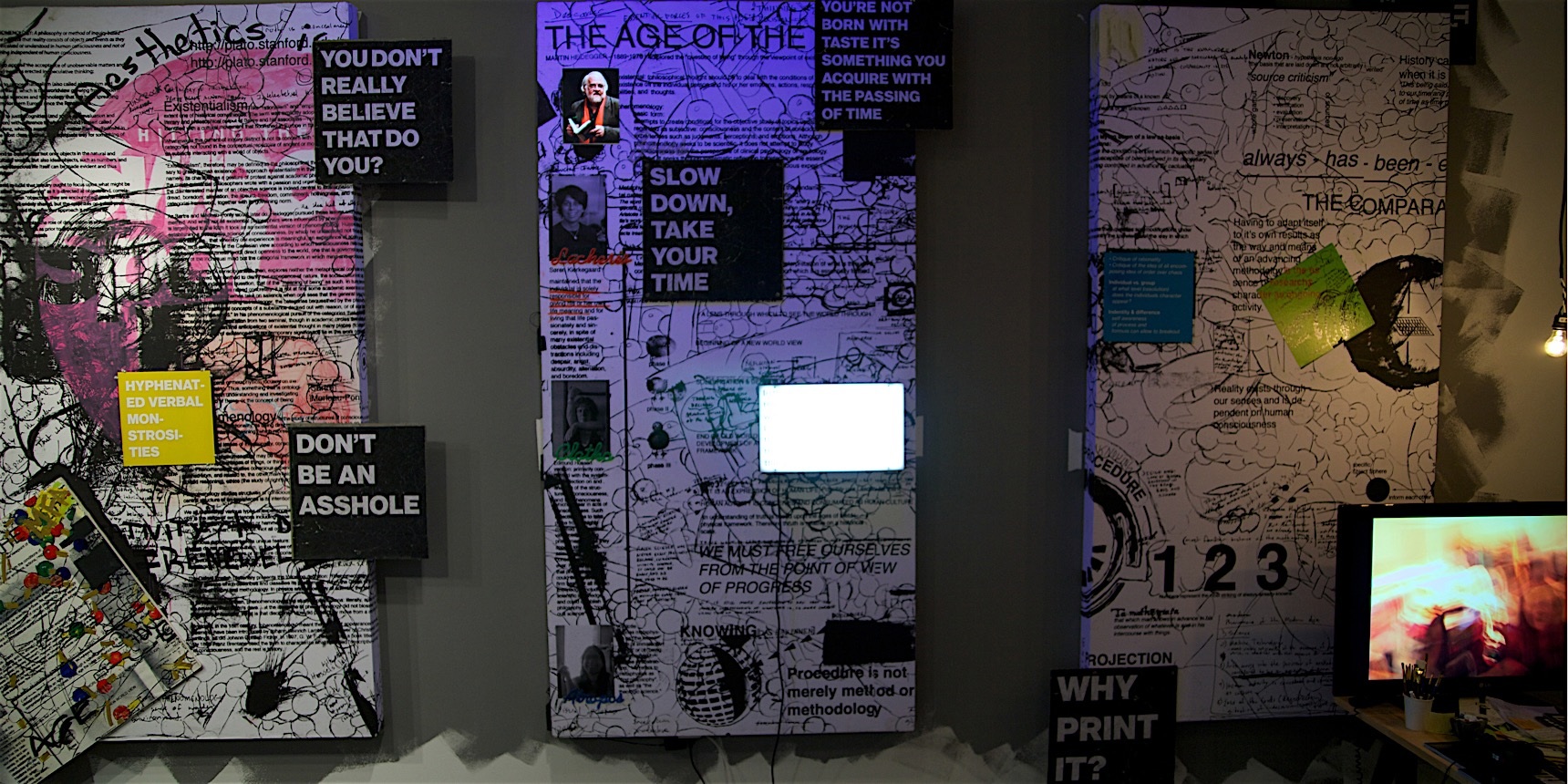 Three large mixed-media wall panels combine text, drawings, screens, photographs, and printed fragments.
